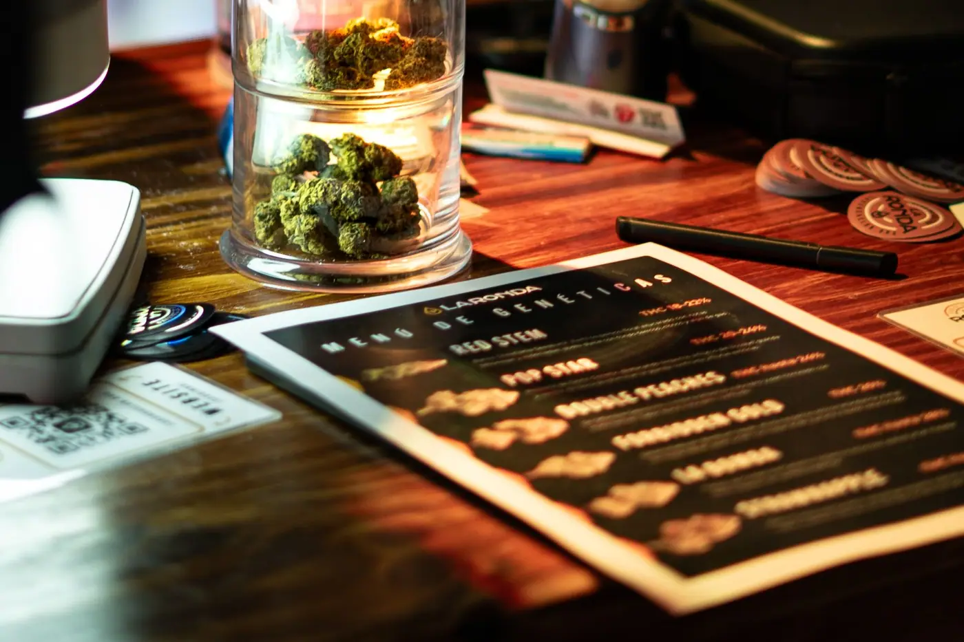 Glass jars of cannabis arranged on a dispensary counter